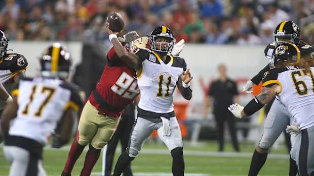 Pittsburgh Maulers Troy Willaims (11) throws downfield before being tackled by Birmingham Stallions Dondrea Tillman (99) during the second half of the USFL Championship game Saturday evening at Tom Benson Stadium in Canton, OH.